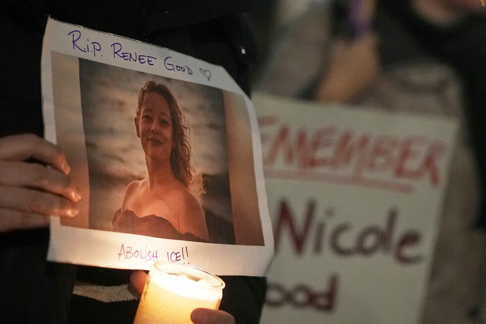 People attend a candlelight vigil at US Embassy in London, Monday, Jan. 12, 2026, for US...